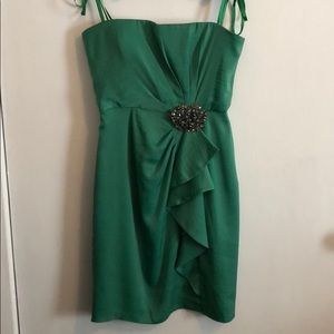 Strapless mini dress with removable broach.
